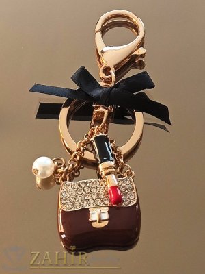  Дамска чанта талисман 3 на 2 см с бели кристали, червило, панделка и перла на позлатен ключодържател 10 см - KL1156