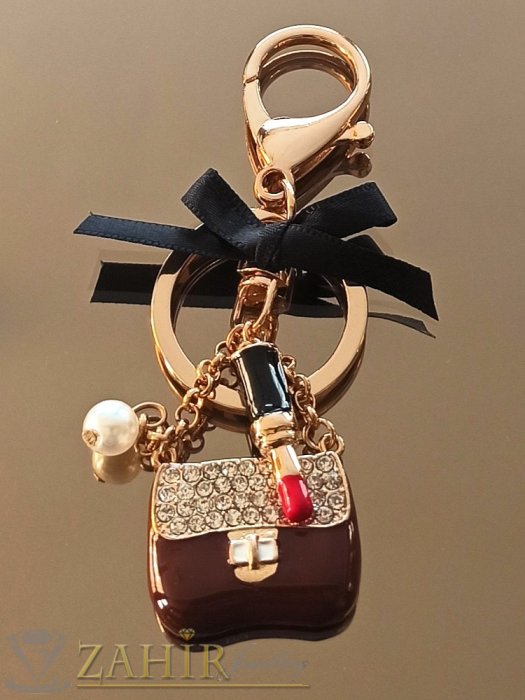 Аксесоари за коса - Дамска чанта талисман 3 на 2 см с бели кристали, червило, панделка и перла на позлатен ключодържател 10 см - KL1156